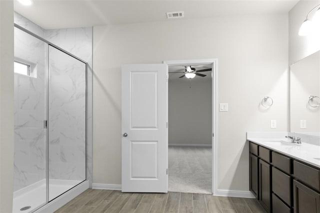 bathroom featuring walk in shower and vanity