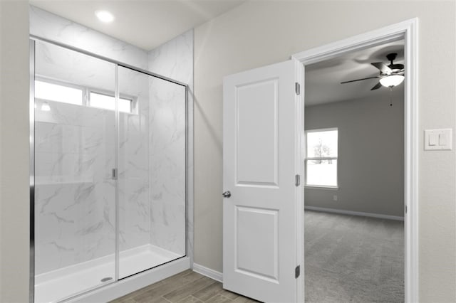 bathroom featuring ceiling fan and walk in shower