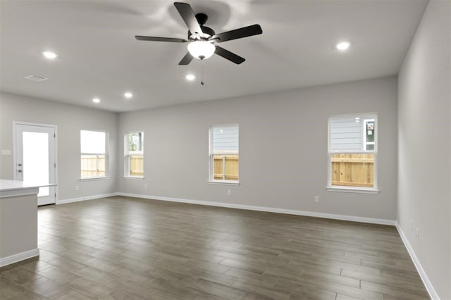 unfurnished room with dark wood-type flooring and ceiling fan