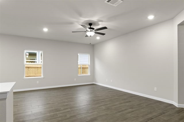 unfurnished room with dark hardwood / wood-style floors and ceiling fan