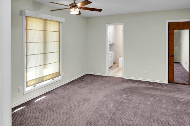 empty room with ceiling fan and carpet floors