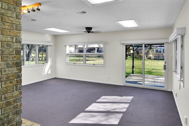 carpeted empty room featuring a textured ceiling and ceiling fan