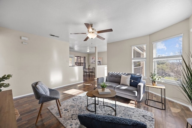 living room featuring ceiling fan and hardwood / wood-style flooring