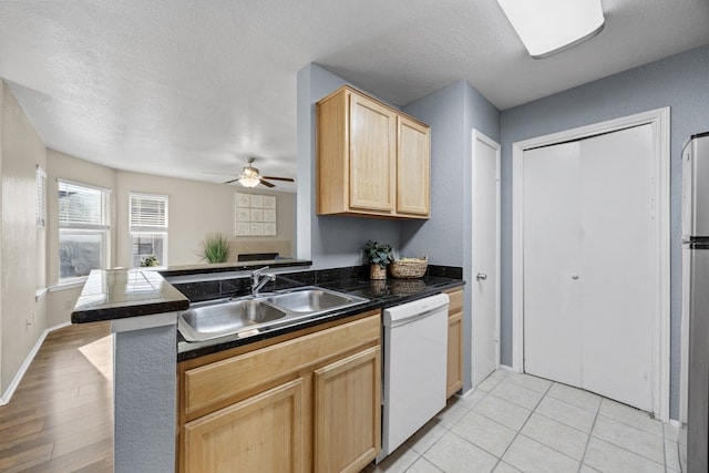 kitchen featuring kitchen peninsula, light brown cabinetry, ceiling fan, sink, and dishwasher