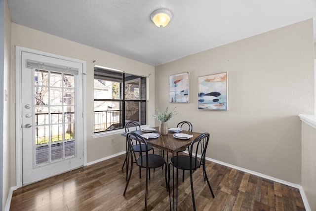 dining area with dark hardwood / wood-style flooring