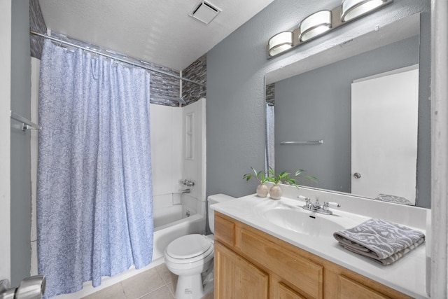 full bathroom featuring tile patterned floors, vanity, a textured ceiling, shower / bathtub combination with curtain, and toilet