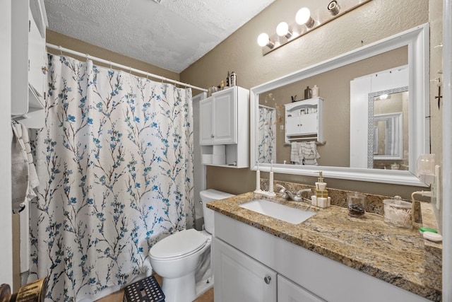 bathroom with a shower with curtain, vanity, toilet, and a textured ceiling