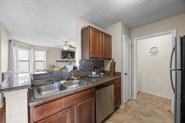 kitchen with sink, ceiling fan, tasteful backsplash, kitchen peninsula, and stainless steel appliances