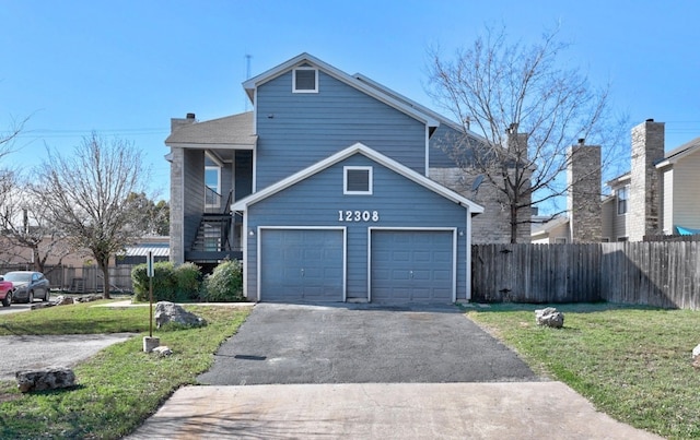 view of front of house featuring a front lawn and a garage