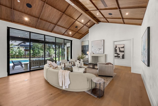 living room featuring beamed ceiling, light hardwood / wood-style floors, high vaulted ceiling, and wood ceiling