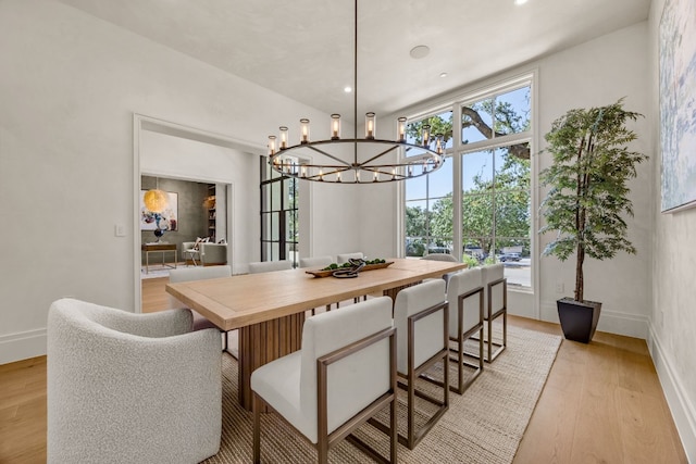 dining area with a notable chandelier and light wood-type flooring