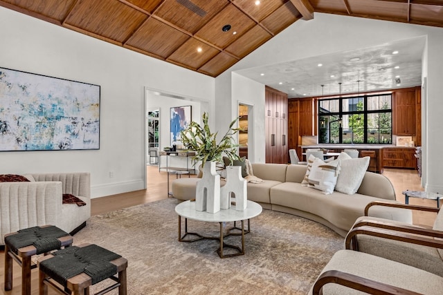 living room with vaulted ceiling with beams, wood ceiling, and light wood-type flooring