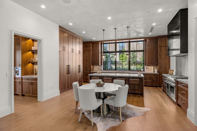 dining space featuring light hardwood / wood-style floors and sink