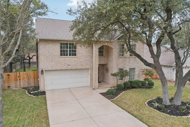 view of front of house featuring a garage and a front lawn