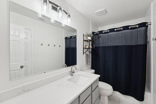 bathroom with tile patterned flooring, vanity, and toilet