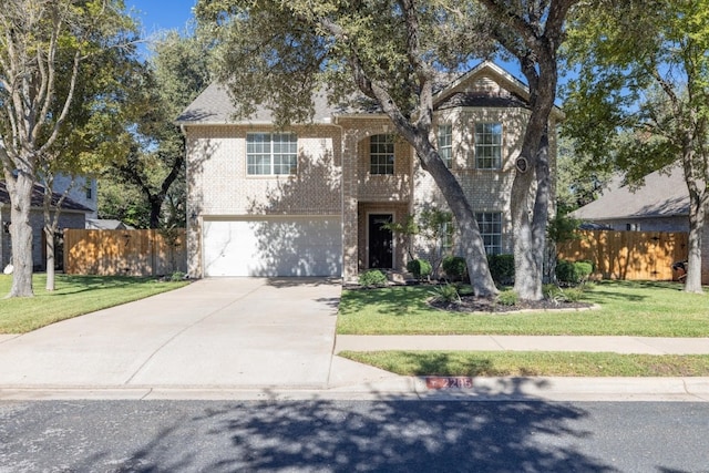 view of property with a front yard and a garage