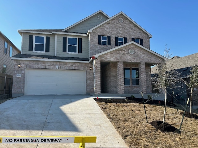 view of front of house featuring an attached garage, concrete driveway, and brick siding