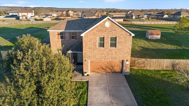 view of front of home featuring a front yard and a garage