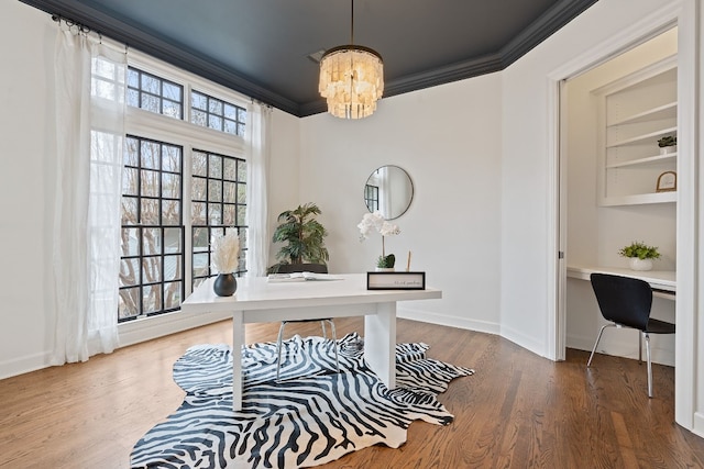 office with a chandelier, wood-type flooring, and ornamental molding