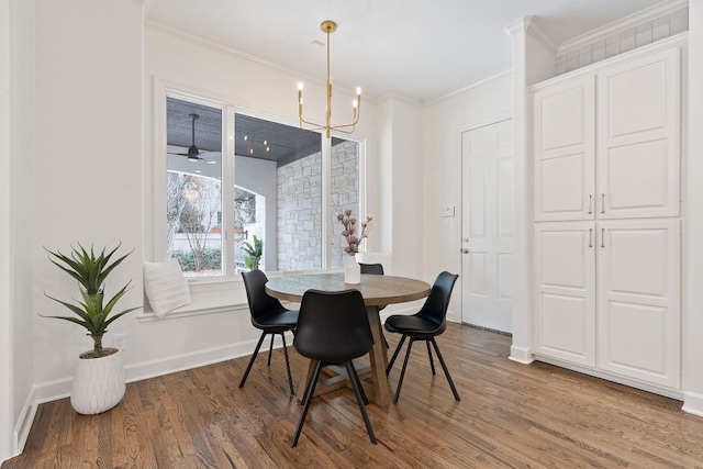 dining room with ceiling fan with notable chandelier, crown molding, and dark wood-type flooring