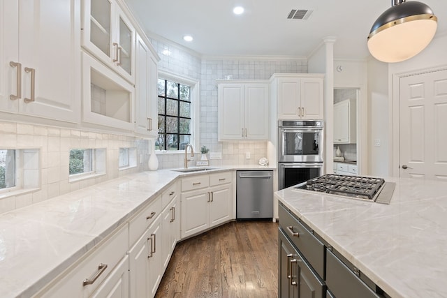 kitchen featuring white cabinetry, sink, dark wood-type flooring, and appliances with stainless steel finishes