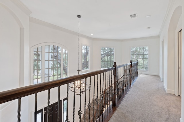 hall featuring light colored carpet and crown molding