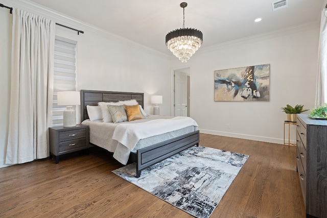 bedroom featuring dark wood-type flooring, crown molding, and a notable chandelier