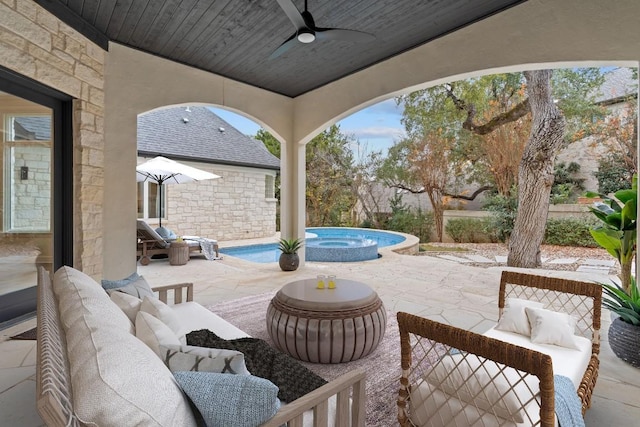 view of patio / terrace featuring ceiling fan and a pool with hot tub