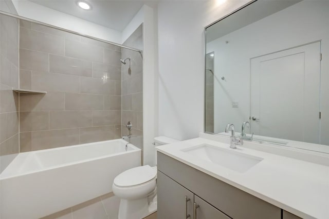 full bathroom with tile patterned floors, toilet, vanity, and tiled shower / bath