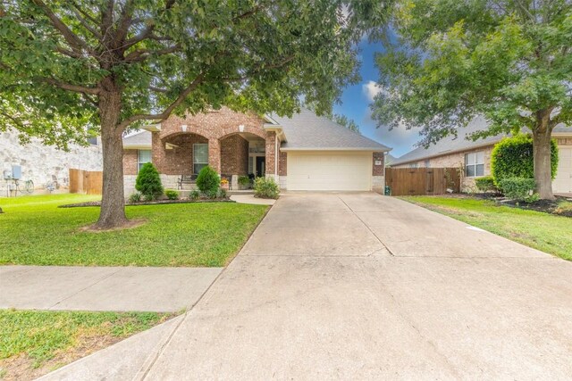 view of front of house featuring a front lawn and a garage