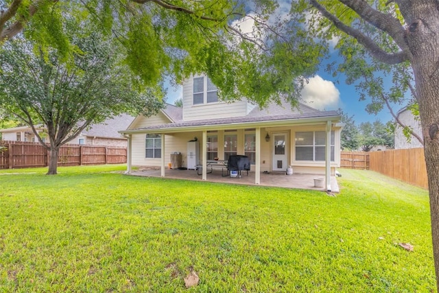 rear view of property with a patio area and a lawn