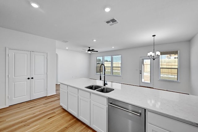 kitchen featuring light wood finished floors, visible vents, a sink, white cabinets, and stainless steel dishwasher