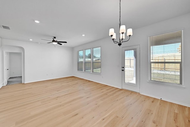 interior space featuring visible vents, recessed lighting, light wood-style flooring, ceiling fan with notable chandelier, and arched walkways