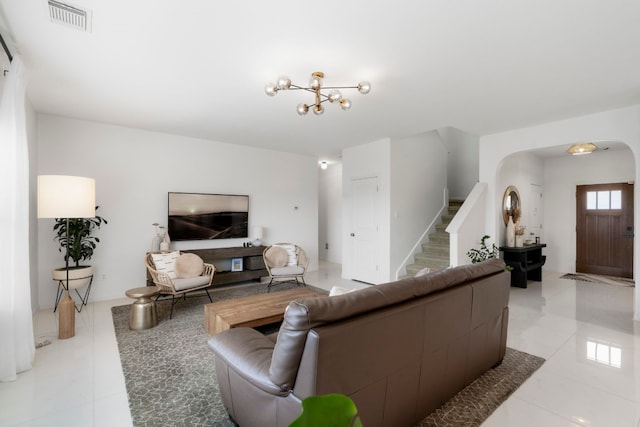 living room with light tile patterned floors and a notable chandelier