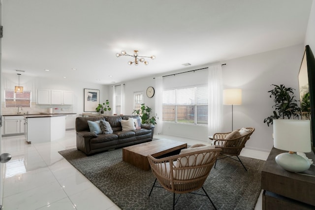 living room featuring a notable chandelier and sink