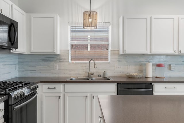 kitchen featuring backsplash, sink, decorative light fixtures, white cabinetry, and stainless steel appliances