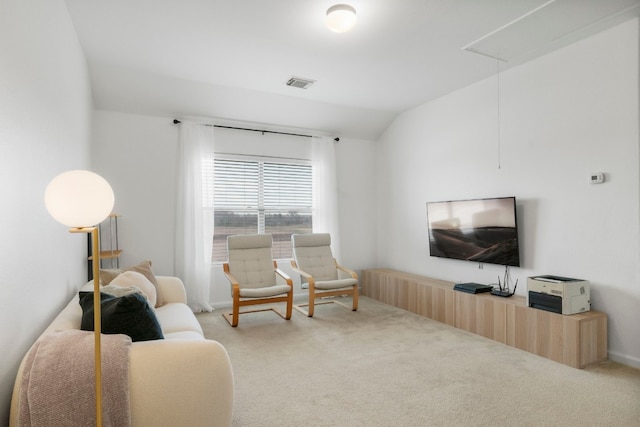 carpeted living room featuring vaulted ceiling