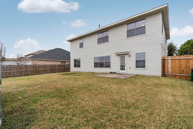 back of property featuring a lawn and a patio area