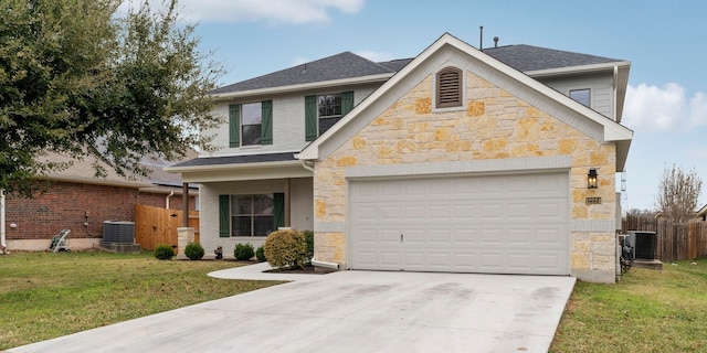 view of front of home featuring central AC, a garage, and a front lawn