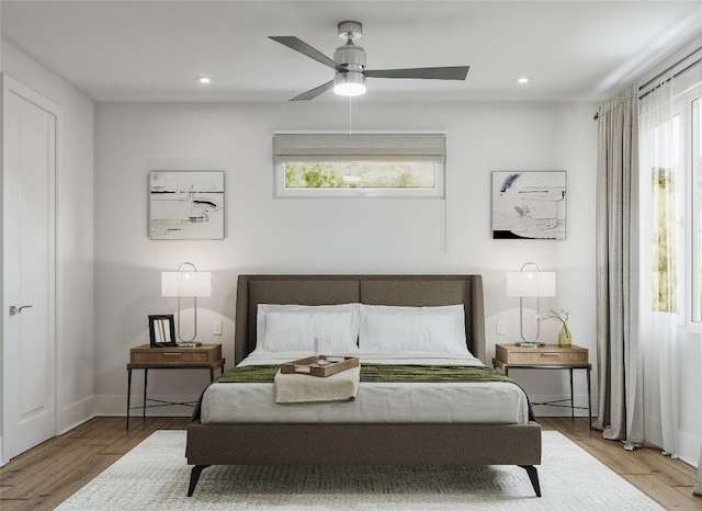 bedroom featuring multiple windows, light wood-type flooring, and ceiling fan