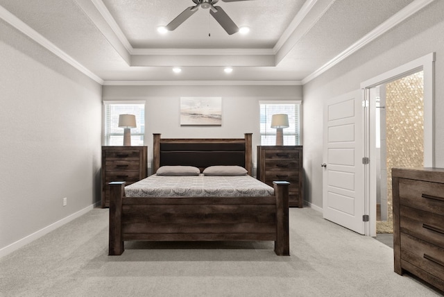 carpeted bedroom featuring ceiling fan, a raised ceiling, and multiple windows