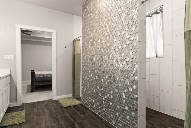 bathroom featuring a shower and vanity