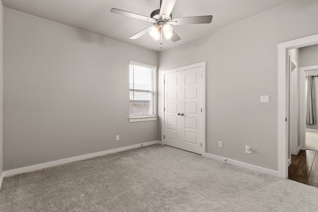 unfurnished bedroom with ceiling fan and light carpet