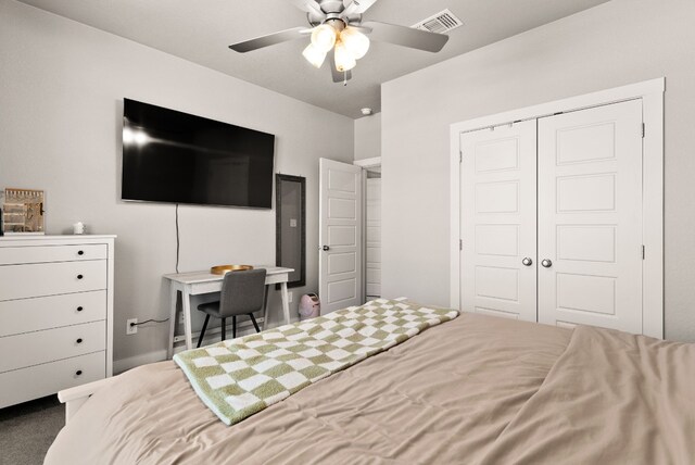 carpeted bedroom with ceiling fan and a closet