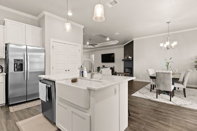 kitchen featuring white cabinetry, sink, stainless steel appliances, a center island with sink, and ceiling fan with notable chandelier