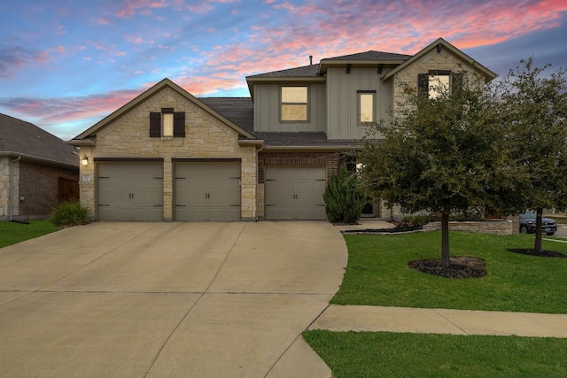 view of front of home with a yard and a garage