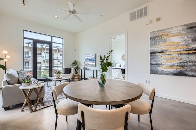 dining room featuring concrete flooring and ceiling fan