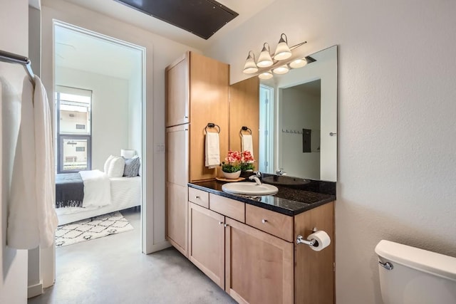 bathroom with vanity, concrete floors, and toilet