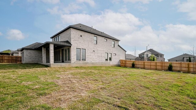 267 Carpenter Hill Dr, Buda, TX 78610 - back of property featuring a fenced backyard and brick siding