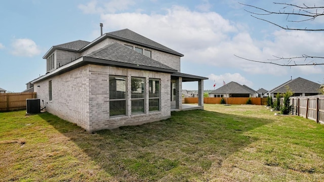 267 Carpenter Hill Dr, Buda, TX 78610 - back of property featuring a fenced backyard, brick siding, and a shingled roof